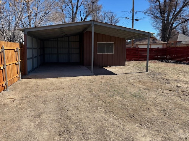 exterior space featuring driveway and fence