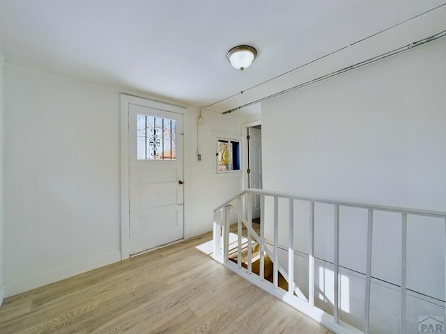 entryway with light wood-style floors and baseboards