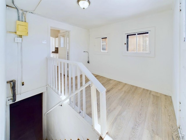 stairs featuring wood finished floors