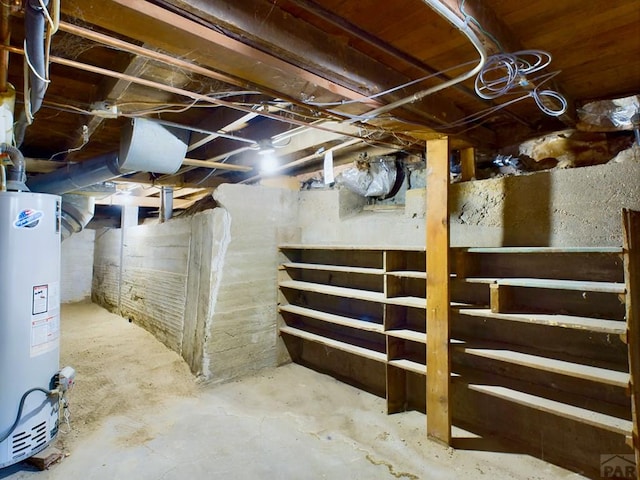 unfinished basement featuring gas water heater