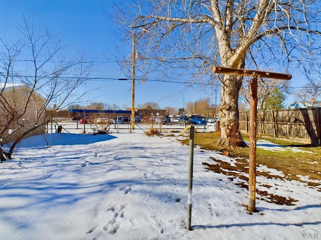 snowy yard with fence