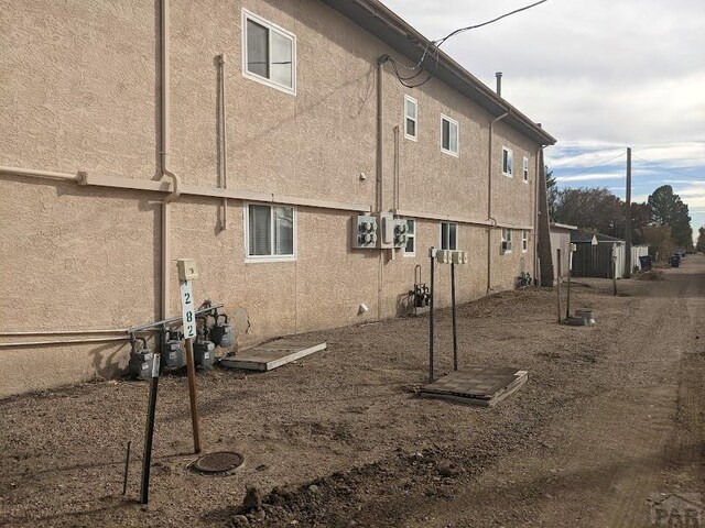 view of side of property with stucco siding