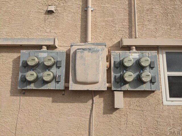 exterior details with electric meter and stucco siding