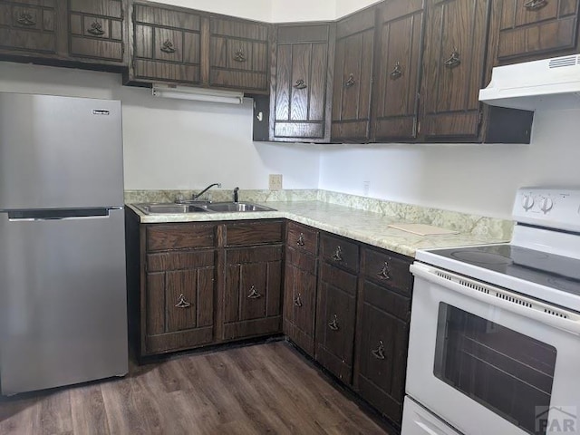 kitchen featuring freestanding refrigerator, light countertops, white electric range, under cabinet range hood, and a sink