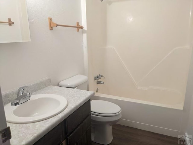 full bathroom with vanity, wood finished floors, shower / tub combination, and toilet