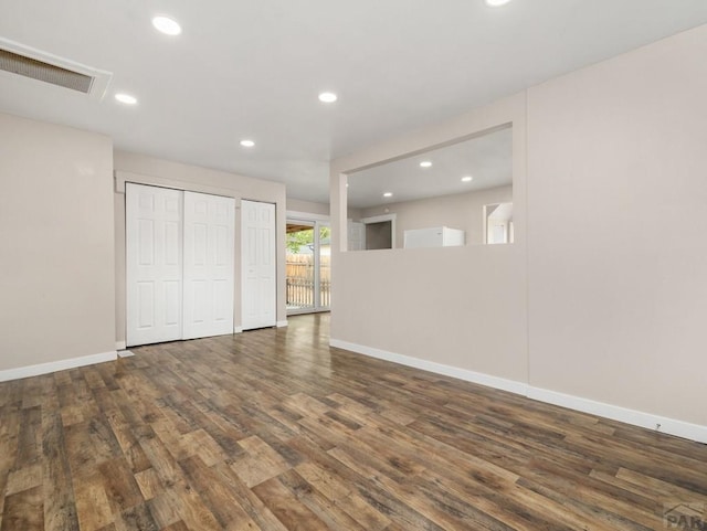 2619 7th Ave, Pueblo, CO 81003 - unfurnished bedroom with wood finished floors, baseboards, recessed lighting, and two closets