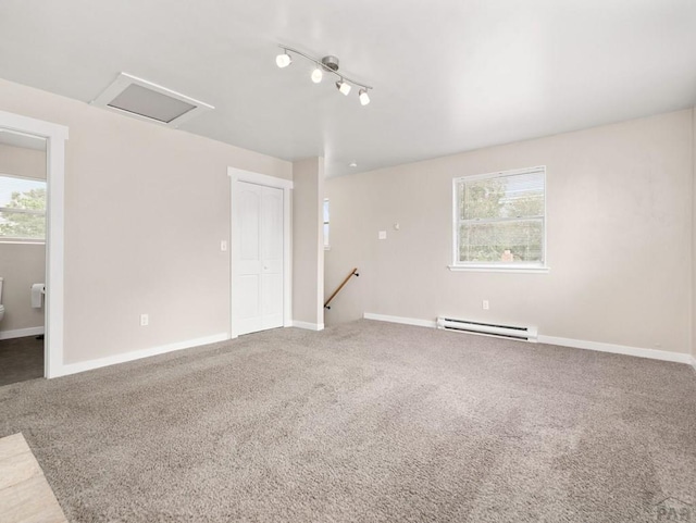 2619 7th Ave, Pueblo, CO 81003 - carpeted spare room featuring a baseboard heating unit, attic access, healthy amount of natural light, and baseboards