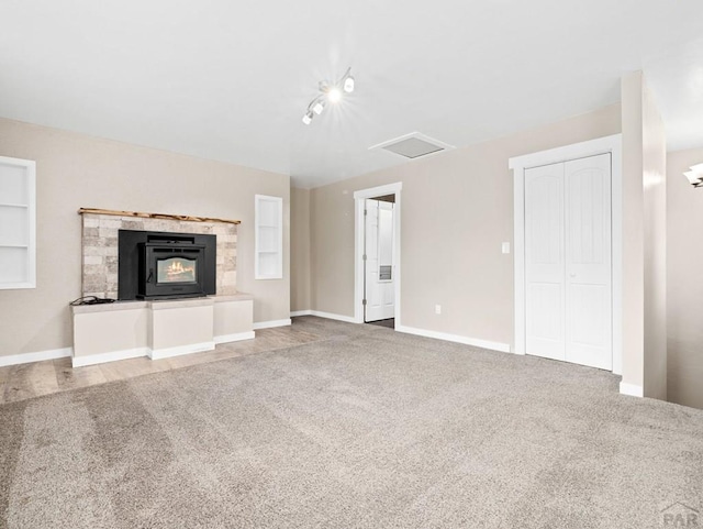 2619 7th Ave, Pueblo, CO 81003 - unfurnished living room with carpet flooring, baseboards, and a warm lit fireplace