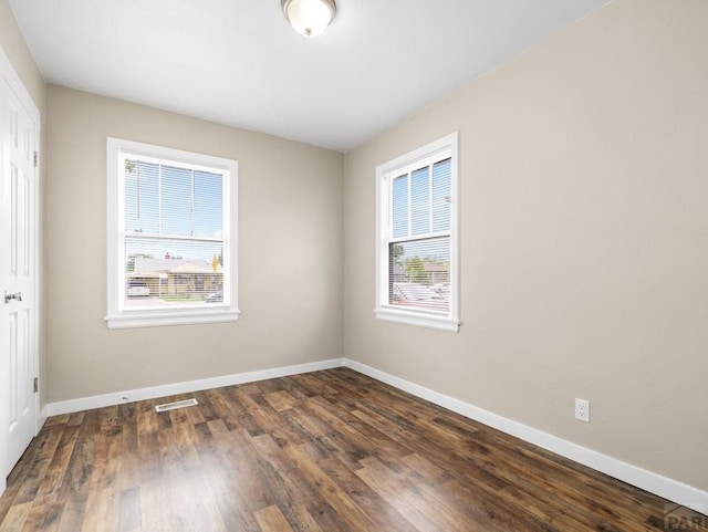 2619 7th Ave, Pueblo, CO 81003 - unfurnished bedroom with a closet, baseboards, and dark wood-type flooring