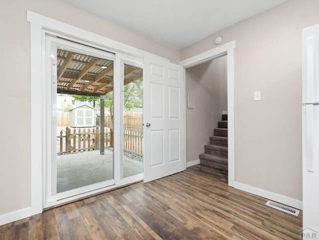 2619 7th Ave, Pueblo, CO 81003 - doorway to outside with wood finished floors, baseboards, and stairs