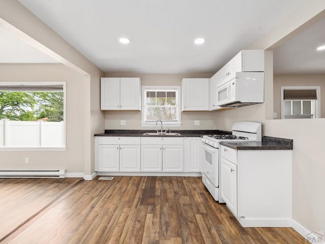 2619 7th Ave, Pueblo, CO 81003 - kitchen with white appliances, a sink, plenty of natural light, dark countertops, and recessed lighting