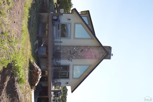 205 Hoofprint Ct, Walsenburg, CO 81089 - view of front facade with stucco siding, stairway, and stone siding