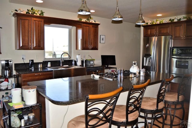 205 Hoofprint Ct, Walsenburg, CO 81089 - kitchen featuring appliances with stainless steel finishes, a kitchen bar, recessed lighting, hanging light fixtures, and a center island