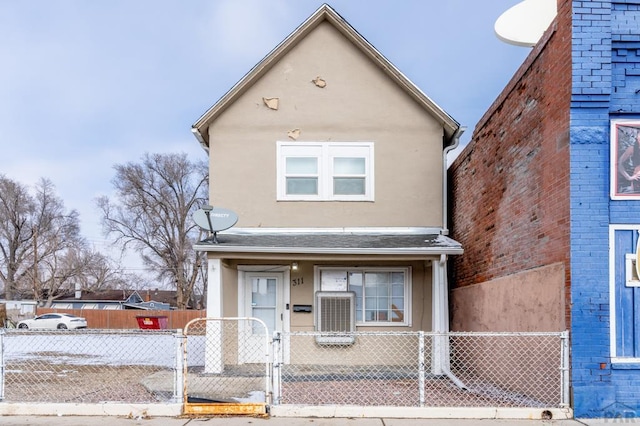 multi unit property featuring a fenced front yard, a gate, roof with shingles, and stucco siding