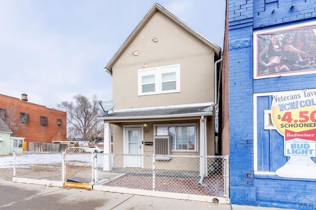 view of front of house with a fenced front yard and stucco siding