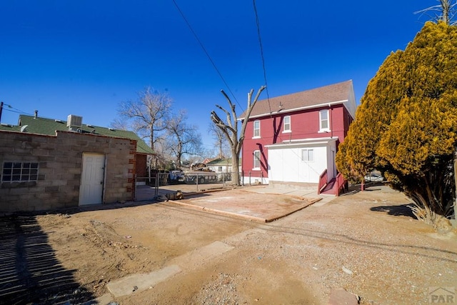 exterior space with driveway, fence, and cooling unit