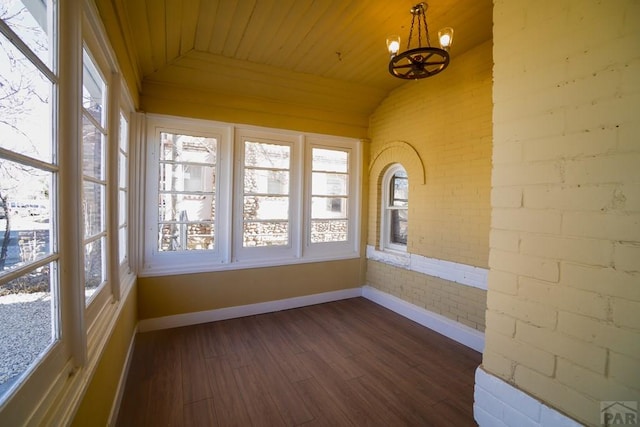 unfurnished sunroom with vaulted ceiling, wooden ceiling, and an inviting chandelier