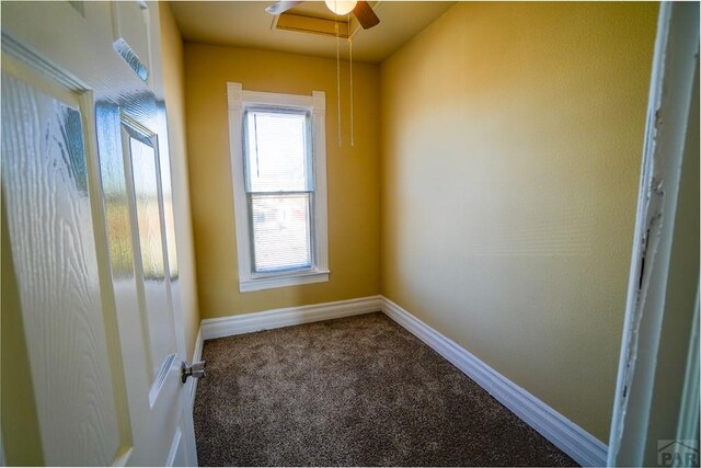 carpeted empty room featuring baseboards