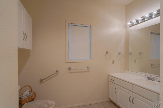 bathroom featuring tile patterned flooring, baseboards, and vanity