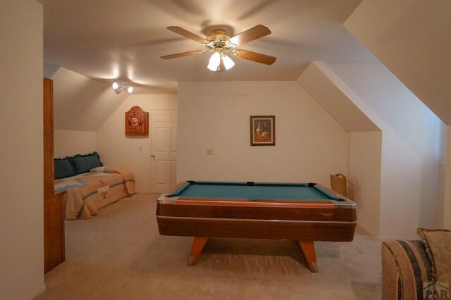 rec room with billiards, vaulted ceiling, a ceiling fan, and light colored carpet