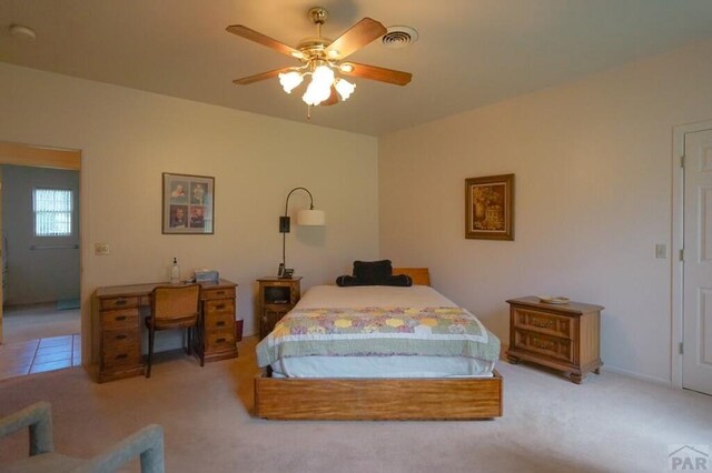 bedroom featuring light carpet, visible vents, and a ceiling fan