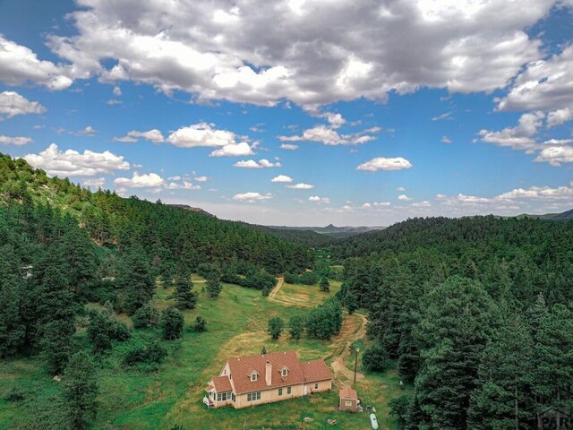 aerial view featuring a wooded view