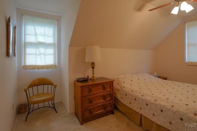 bedroom featuring light carpet, vaulted ceiling, and ceiling fan