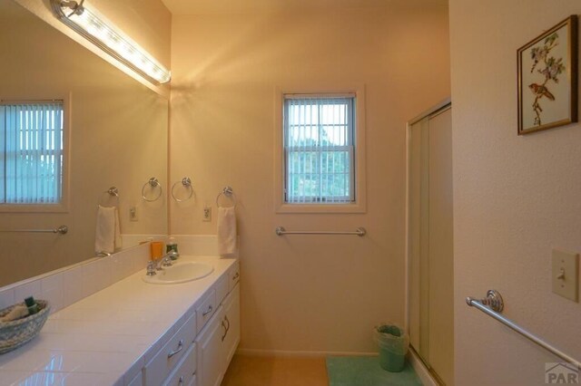 full bathroom featuring an enclosed shower and vanity