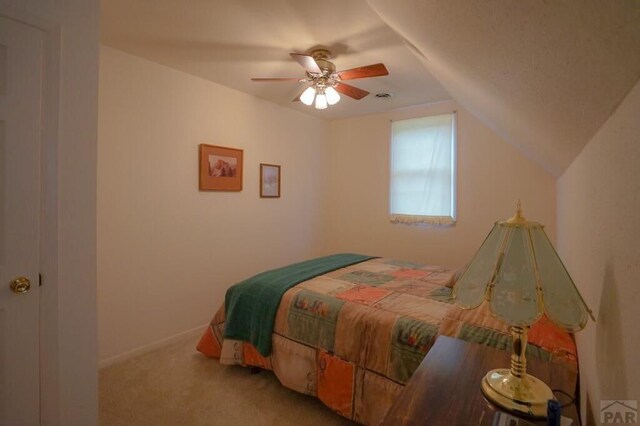 bedroom with lofted ceiling, carpet floors, ceiling fan, and baseboards