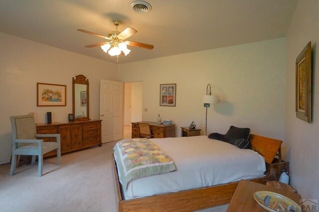 bedroom with a ceiling fan, light colored carpet, and visible vents