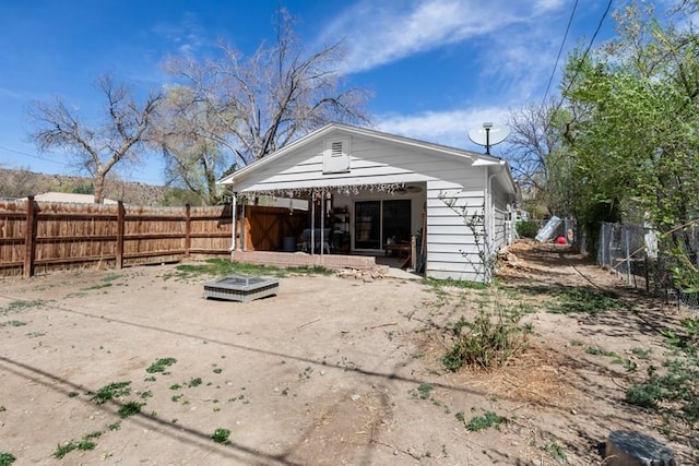 back of property featuring a fenced backyard