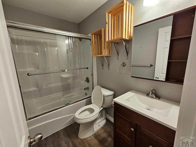 full bath featuring enclosed tub / shower combo, vanity, toilet, and wood finished floors