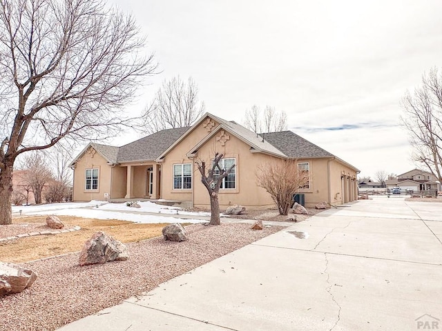 view of front of house with concrete driveway and stucco siding