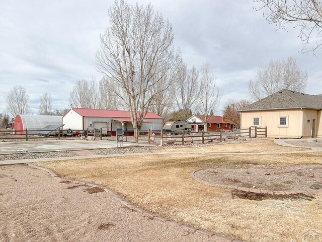 view of yard featuring fence and an outdoor structure