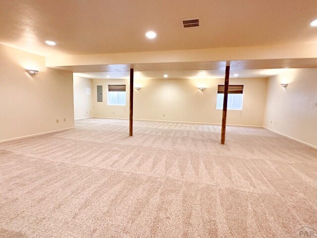 below grade area featuring baseboards, recessed lighting, visible vents, and light colored carpet