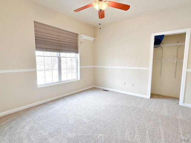 unfurnished bedroom featuring carpet, a closet, ceiling fan, and baseboards