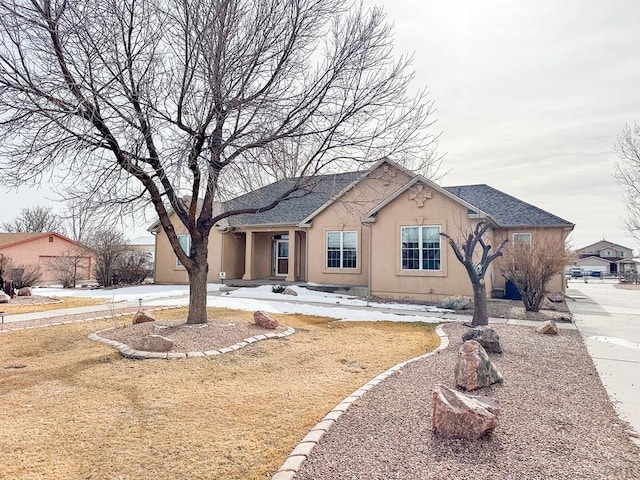 single story home featuring roof with shingles and stucco siding