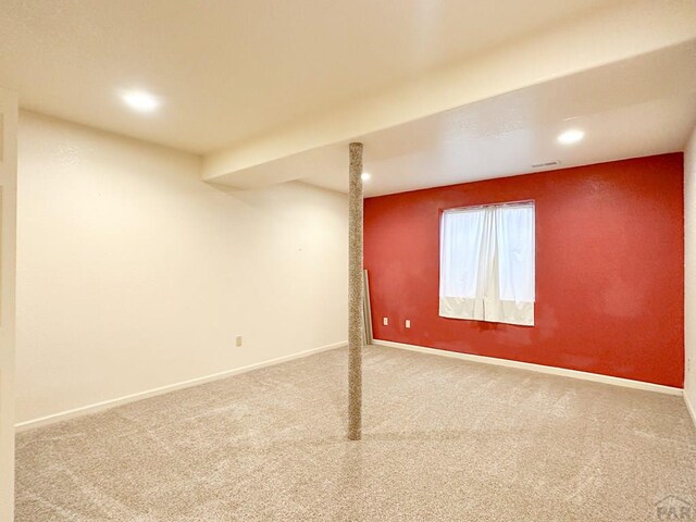 basement featuring carpet, baseboards, and recessed lighting