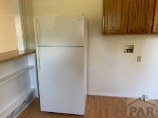 417 Park Dr, Pueblo, CO 81005 - laundry room featuring wood finished floors, hookup for a washing machine, cabinet space, and baseboards