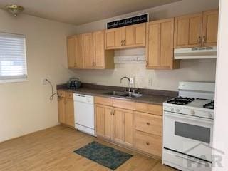417 Park Dr, Pueblo, CO 81005 - kitchen featuring white appliances, under cabinet range hood, light brown cabinetry, a sink, and dark countertops