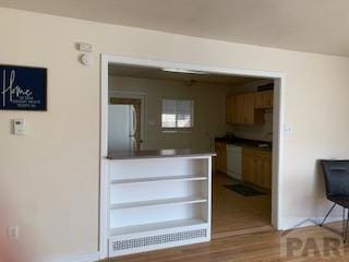 417 Park Dr, Pueblo, CO 81005 - kitchen with white appliances, wood finished floors, and baseboards
