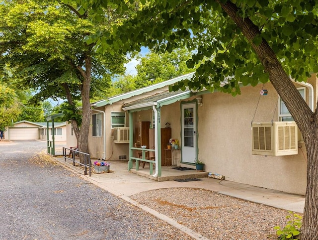 417 Park Dr, Pueblo, CO 81005 - view of front of property featuring stucco siding, an outbuilding, and cooling unit