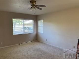 417 Park Dr, Pueblo, CO 81005 - carpeted empty room with ceiling fan, baseboards, and a baseboard heating unit