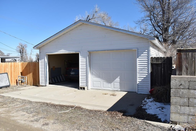 detached garage featuring fence