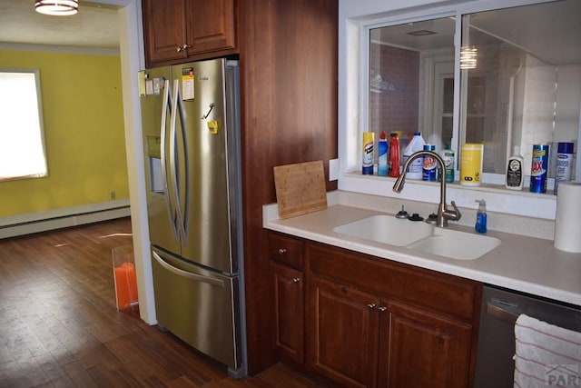 kitchen featuring stainless steel fridge with ice dispenser, a baseboard radiator, light countertops, dishwashing machine, and a sink