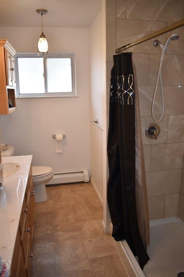 bathroom featuring a baseboard radiator, toilet, a stall shower, and vanity