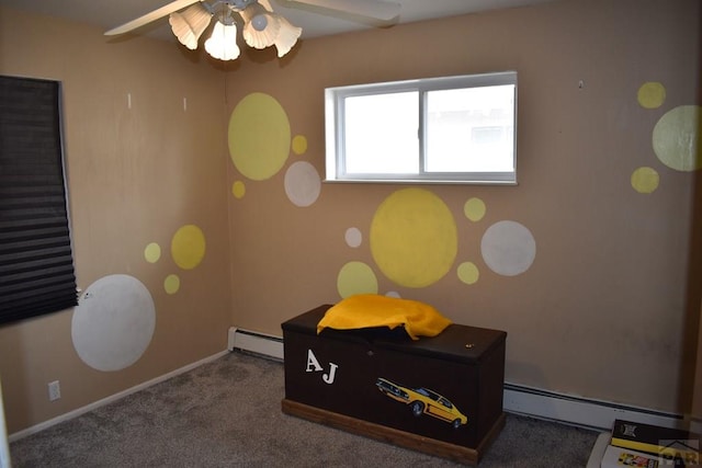 interior space featuring baseboards, baseboard heating, ceiling fan, and carpet