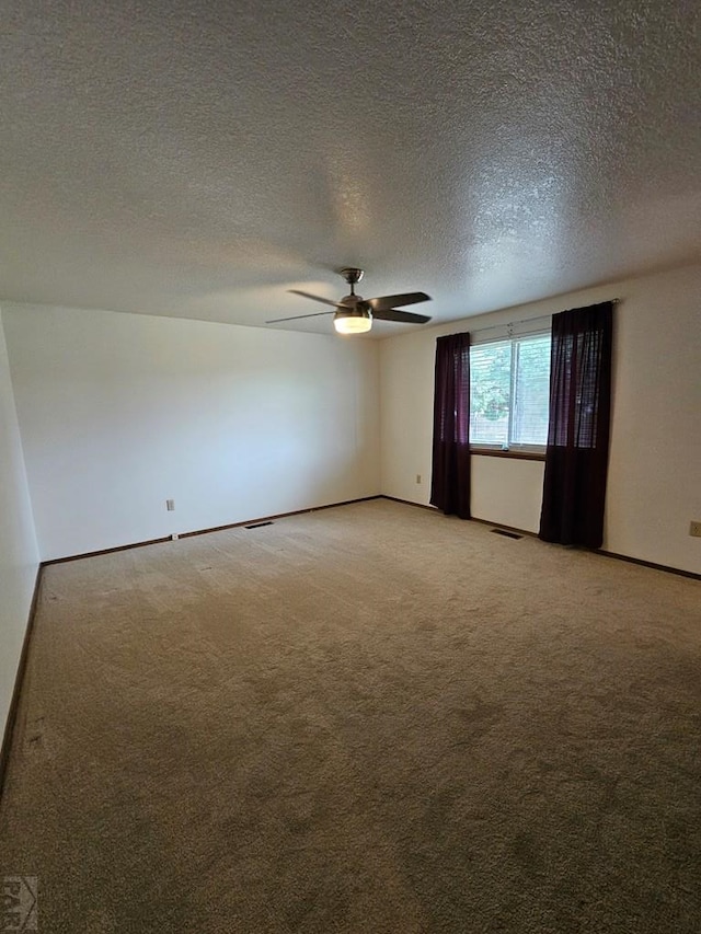 789 W 4th Ave, Springfield, CO 81073 - unfurnished room featuring light colored carpet, a ceiling fan, a textured ceiling, and baseboards