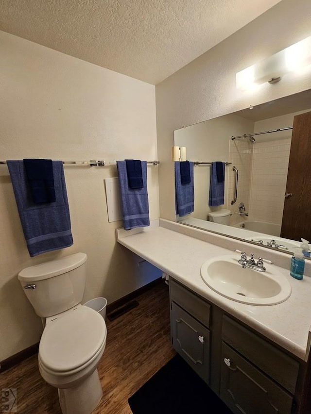 789 W 4th Ave, Springfield, CO 81073 - full bathroom with toilet, wood finished floors, vanity, shower / bathtub combination, and a textured ceiling