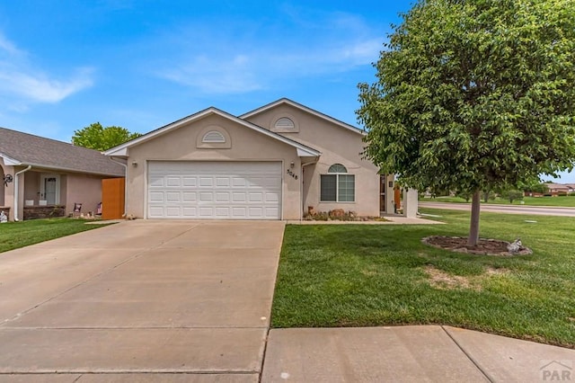 5048 Sage St, Pueblo, CO 81005 - view of front facade featuring stucco siding, concrete driveway, a garage, and a front yard